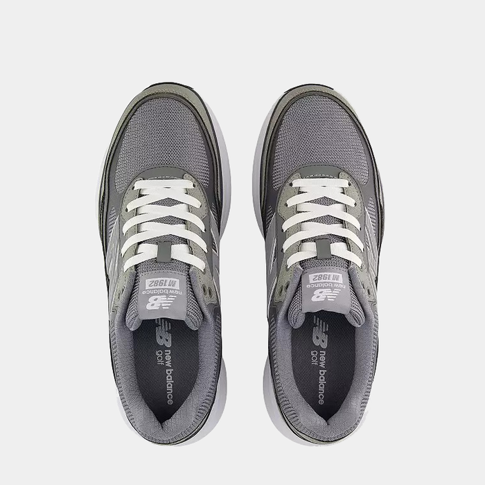 New Balance Golf 1982 Golf shoes in gray with white laces and mesh upper, top view showing tongue branding and cushioned collar.