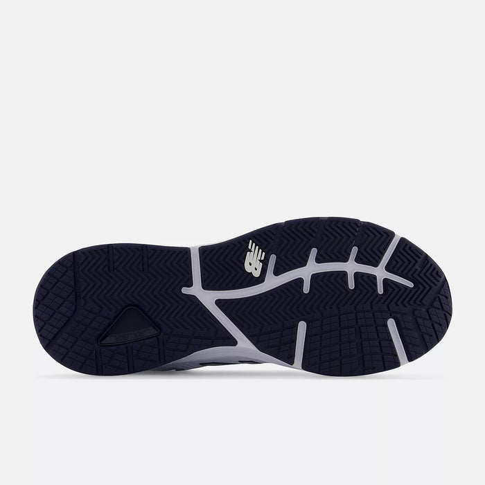 New Balance 857v3 outsole in navy with herringbone tread pattern and white logo detailing.