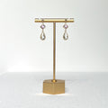 This earring set features a petite pink glass bezel set charm with a clear crystal teardrop shape fancy prong bezel setting hung on a 3mm gold filled earring stud post.