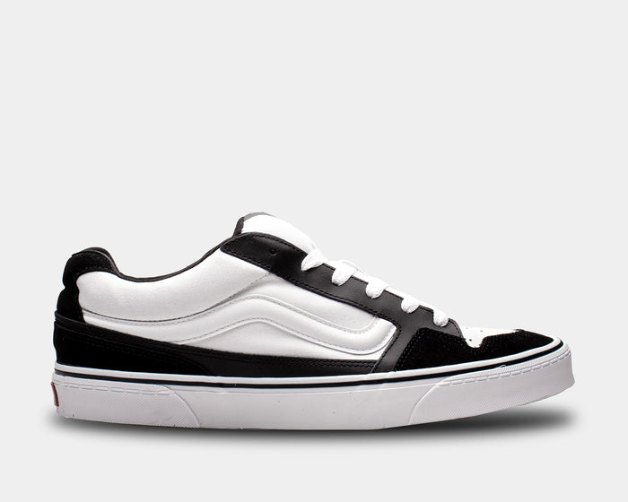 Vans Caldrone sneakers in black and white with suede and canvas upper, thick rubber sole, side view.