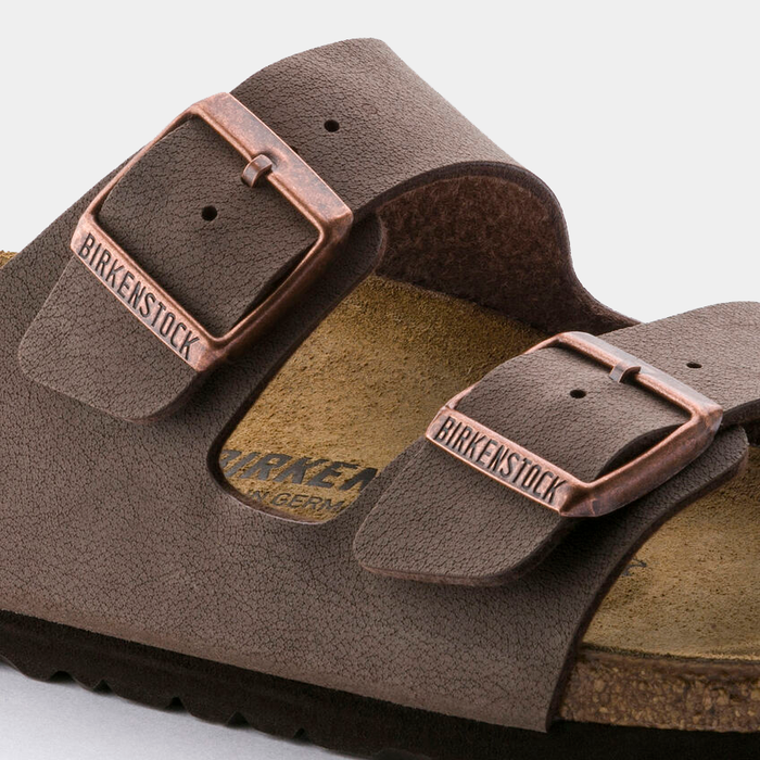 Birkenstock Arizona Birko-Flor® Nubuck sandals in brown with copper-tone buckles and textured upper, close-up side view.