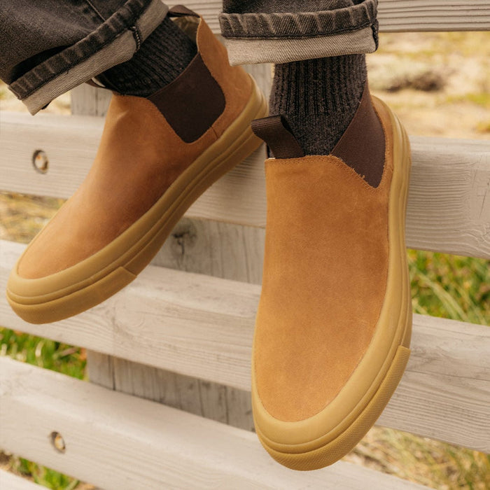 SeaVees Ballard Boot slip-on boots in tan suede with brown elastic panels and gum rubber sole, lifestyle view.