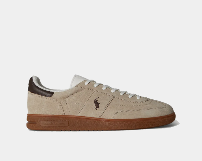 Polo Ralph Lauren Bedford Suede Sneaker in beige suede with brown leather heel detail and gum rubber sole, side view.