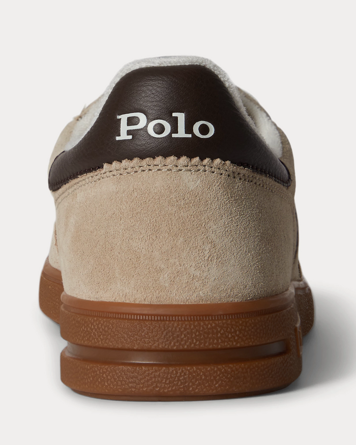 Polo Ralph Lauren Bedford Suede Sneaker in beige suede with brown leather heel tab and gum rubber sole, back view.