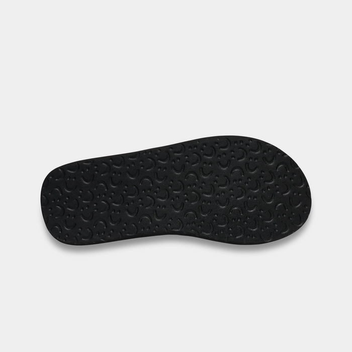 Sanuk Beer Cozy IV sandal outsole in black with textured pattern providing grip and comfort.