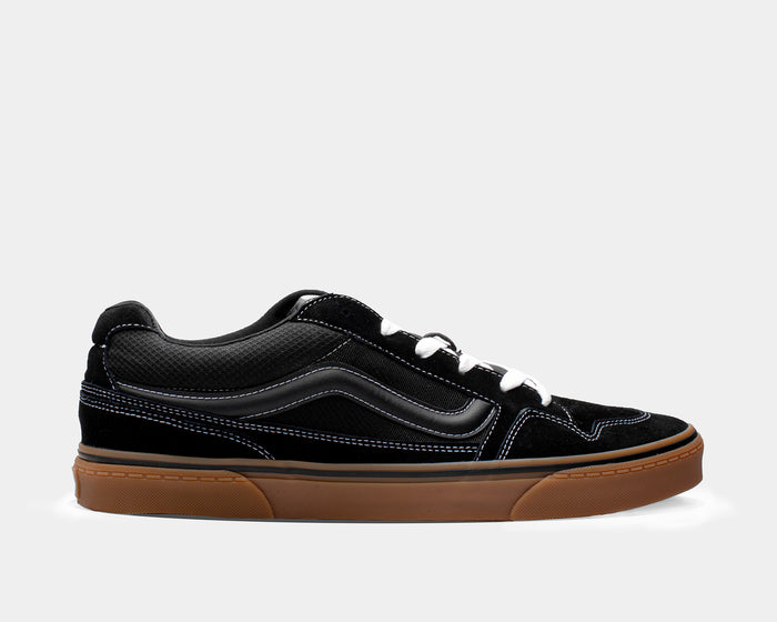 Vans Caldrone skate shoes in black with suede and mesh upper, white stitching, gum outsole, and classic stripe, side view.