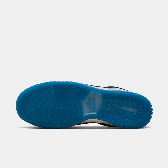 Nike Dunk Low Retro SE sneakers outsole in translucent bright blue rubber with concentric circular tread pattern, bottom view.