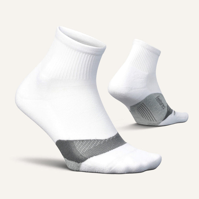 Feetures Elite Light Cushion Quarter socks in white with gray arch support and cushioned sole, side view.