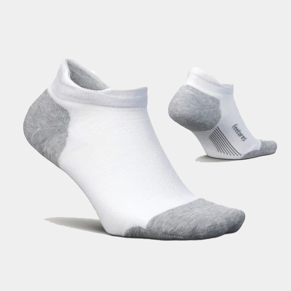 Feetures Elite Max Cushion No Show Tab socks in white with gray heel and toe accents, featuring a seamless design and targeted compression.