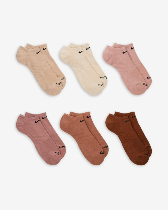 Nike Everyday Plus Cushioned No Show Socks in assorted beige, cream, pink, and brown tones with black logo detailing, front view.