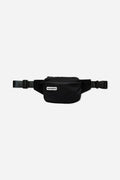 Nomadix Fanny Pack in black featuring a zippered main compartment, adjustable strap, and buckle closure, front view.