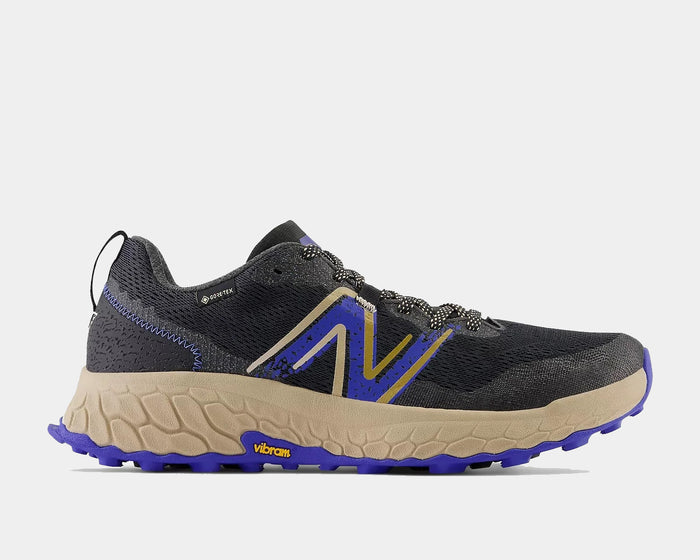 New Balance Fresh Foam X Hierro v7 Gore-Tex trail running shoes in black, beige, and purple with breathable mesh upper and Vibram outsole, side view.