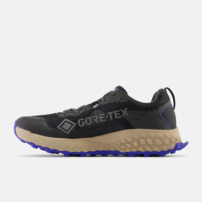New Balance Fresh Foam X Hierro v7 Gore-Tex trail running shoes in black with tan midsoles and purple outsoles, side view.