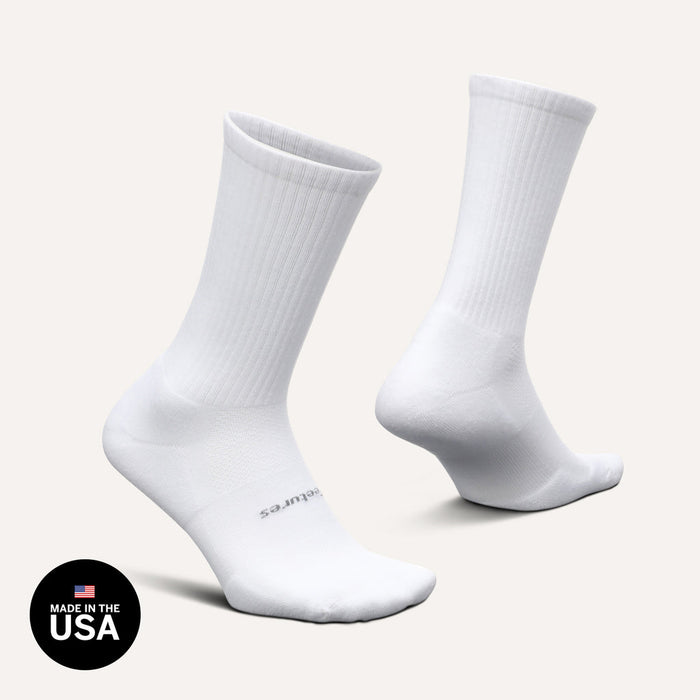 Feetures High Performance Max Cushion Crew socks in white with ribbed crew length design and reinforced cushioning, side angle view.