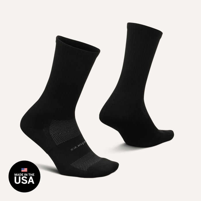 Feetures High Performance Max Cushion Crew socks in black with ribbed cuff, breathable mesh panels, and cushioned sole, side view.