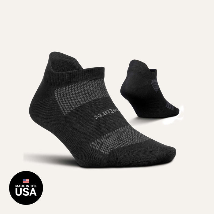 Feetures High Performance Max Cushion No Show Tab socks in black with cushioned sole and moisture-wicking fabric, side view.