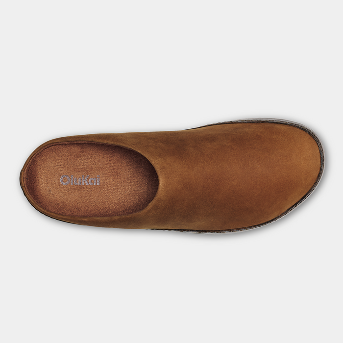 OluKai Ku'u shoes top view in brown leather with a cushioned footbed and minimalist slip-on design.
