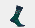 Feetures Limited Edition "Evergreen" Everyday Max Cushion Crew socks in green with navy accents and holiday snowflake pattern, side view.