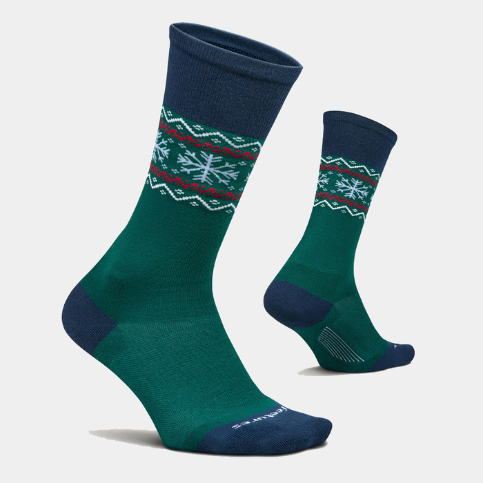 Feetures Limited Edition "Evergreen" Everyday Max Cushion Crew socks in green and navy with festive snowflake and zigzag patterns, side view.