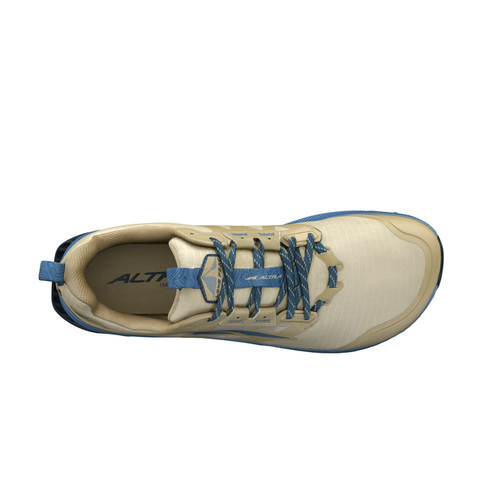 Top view of a beige and blue trail running shoe.