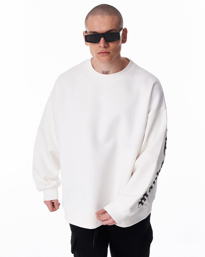 Martin Valen men's white oversized sweatshirt, close frontal crop showing crew neckline and partial black sleeve print