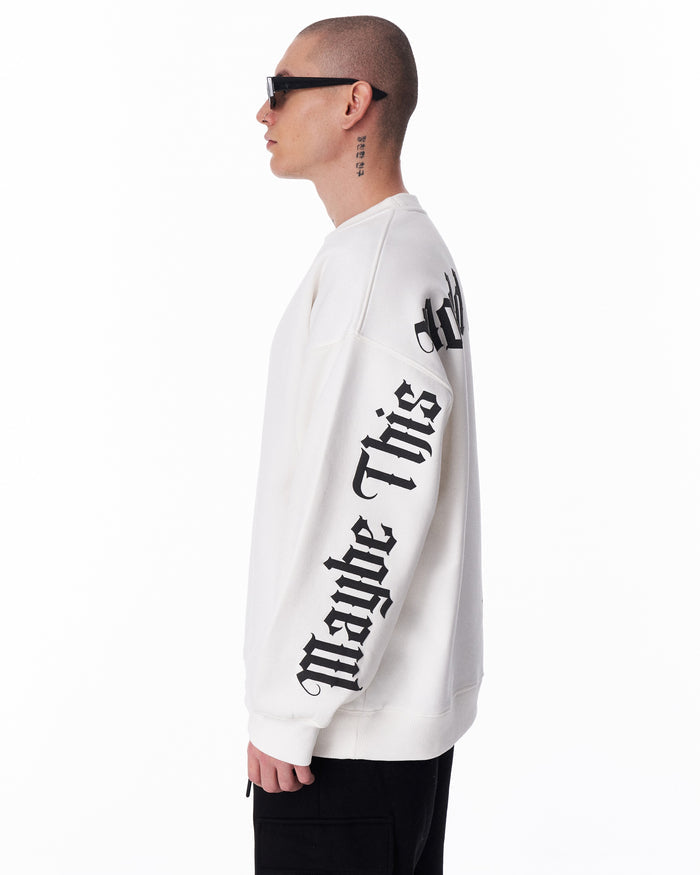 Martin Valen white oversized sweatshirt 'Another World's Hell', partial front view with printed sleeve and left hand relaxed