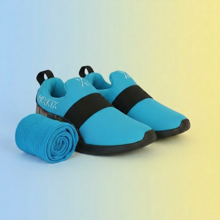 Blue slip-on shoes with black straps and matching children cotton socks on a gradient background