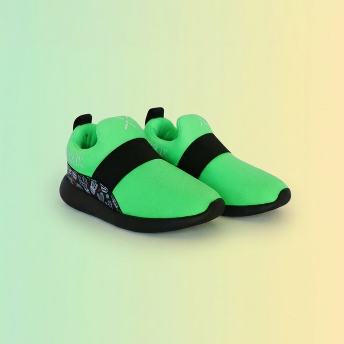 Neon green slip on shoes with black bands on a gradient background