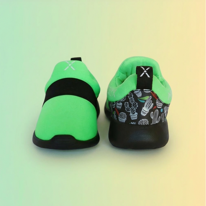 Pair of green and black shoes on a gradient background