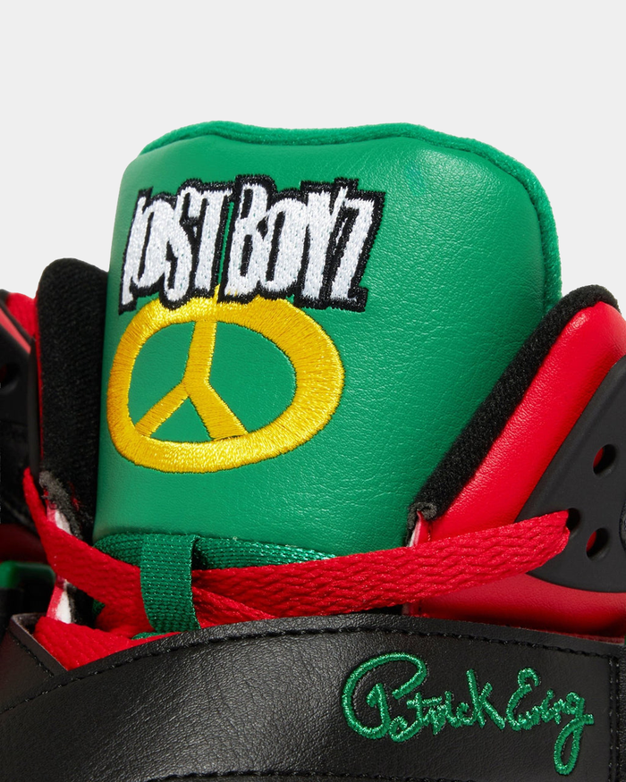 Ewing Athletics ROGUE x LOST BOYZ sneakers with green leather tongue featuring gold peace symbol and "Lost Boyz" embroidery, red laces, and black upper.