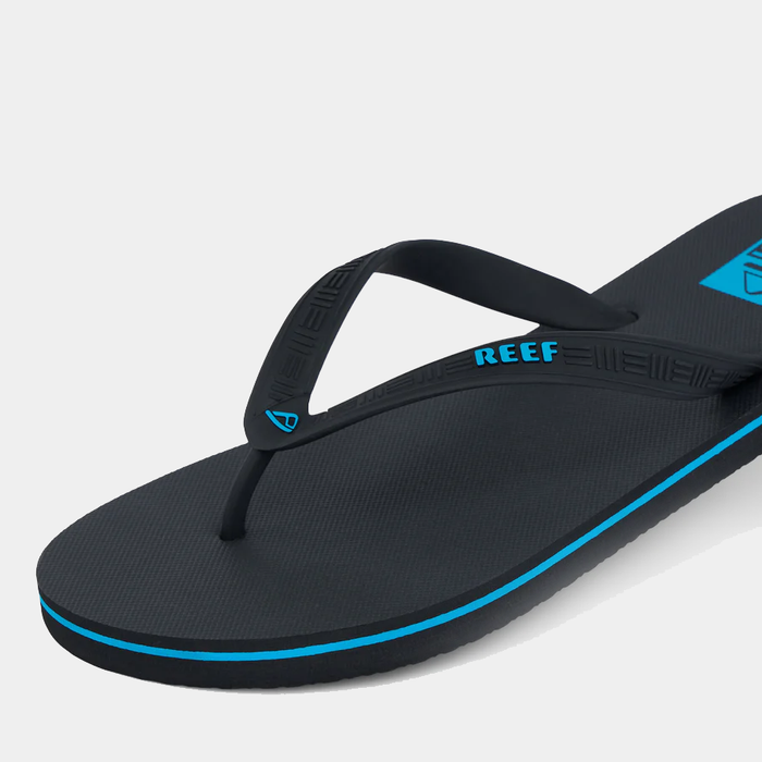 Reef Seaside sandals in black with blue accents and textured footbed, side angle view.