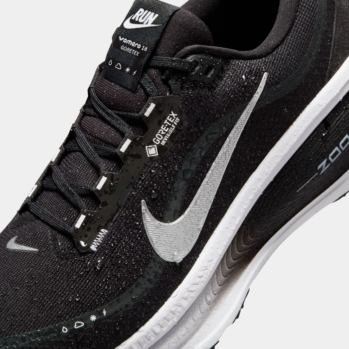 Nike Vomero 18 GORE-TEX running shoes in black with water-resistant GORE-TEX material, silver Swoosh logo, and cushioned sole, close-up view.