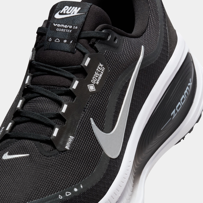 Nike Vomero 18 GORE-TEX running shoes in black with waterproof GORE-TEX upper, silver details, and ZoomX cushioning, angled close-up.